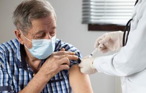 older-senior-wearing-a-mask-getting-vaccinated