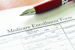 Medicare Enrollment Form and a red pen